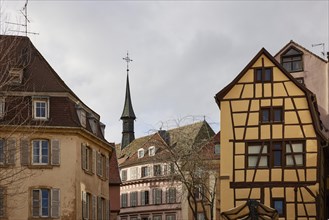 Facades of historic houses with small tower and half-timbered house in the old town centre of