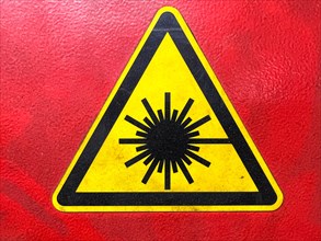 Yellow radiation hazard sign on red background