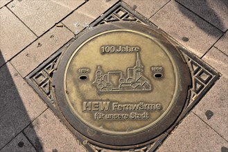 Commemorative plaque on the pavement celebrates 100 years of district heating in Hamburg, Hamburg,