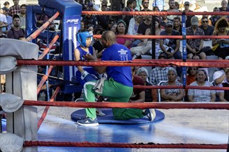 Oaxaca, Mexico, A coach prepares a boy for a youth boxing match in the zocalo, Central America