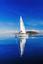 German sailboat sailing in an archipelago with water reflection in the sea a sunny summer day