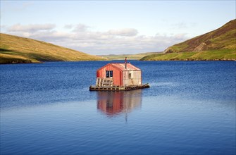 Fisherman's shed on small island, Olna Firth, Voe, Shetland Islands, Scotland, United Kingdom,