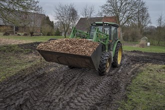 Tractor loaded with woodchippings on a farm, Othenstorf, Mecklenburg-Vorpommern, Germany, Europe