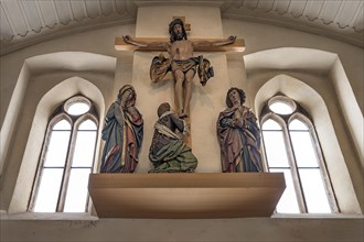 Placed on the west wall is the monumental crucifixion group from around 1510 by the carver Veit