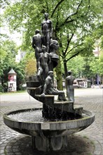 Sculpture fountain with human figures in the park, Hamburg, Hanseatic City of Hamburg, Germany,