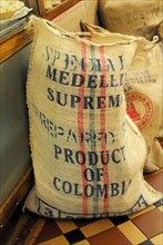 Coffee, A rustic sack labelled 'Medellin Supreme Product of Colombia' presumably for coffee beans,