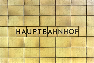 Yellow wall tiles with the lettering 'central railway station' on a railway station wall, Hamburg,