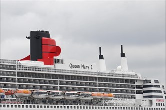 Close-up of a cruise ship smokestack Queen Mary 2, with orange lifeboats, Hamburg, Hanseatic City