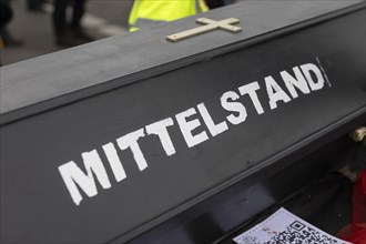 A coffin with the inscription 'AeoeMittelstand'Aeo taken as part of the 'AeoeBauern-Proteste'Aeo in