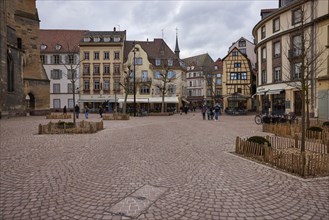 Place de la Cathedrale with cobblestones, historic houses and half-timbered buildings in Colmar,