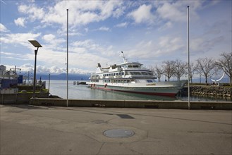 Passenger ship Lausanne moored in Lake Geneva at the pier in Ouchy harbour with the sculpture Eole