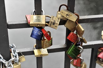 Love locks of young lovers at the Niederbaumbruecke, Speicherstadt, Hamburg harbour, Colourful love