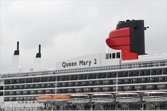 View of the upper decks of a cruise ship, Queen Mary 2, with funnels and lifeboats, Hamburg,