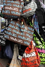 Colourful souvenir bags with the imprint 'Hamburg' stacked for sale, Hamburg, Hanseatic City of