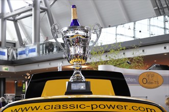 RETRO CLASSICS 2010, Stuttgart Trade Fair Centre, Shiny winner's trophy on a yellow sports car at a