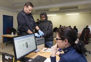 Refugees are registered and recorded by the Federal Police in Rosenheim. A Federal Police officer