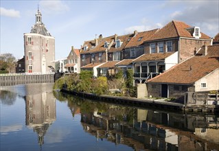 Attractive historic waterside buildings and Drommedaris defence tower, Enkhuizen, Netherlands