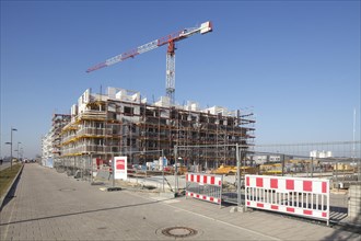 Shells of residential buildings in Bremen's Ueberseestadt, scaffolding, construction site, Bremen
