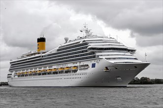 COSTA MAGICA, Large cruise ship with yellow smokestack on moving sea and grey sky, Hamburg,