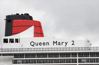View of the funnel of the Queen Mary 2 cruise ship against a cloudy sky, Hamburg, Hanseatic City of