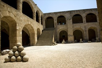 Stone sling shot balls, courtyard, Archaeological museum, Rhodes, Greece, Europe