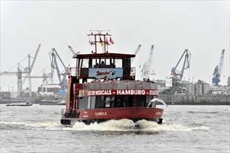 A red excursion boat sails on murky water in the harbour, Hamburg, Hanseatic City of Hamburg,