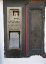 Old disused stamp vending machine and post box, England, UK