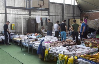Refugees from Syria are housed in a gymnasium at the central contact point for asylum seekers in