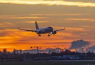 Evening sky with sunset at the airport, aeroplane landing, Stuttgart, Baden-Wuerttemberg, Germany,