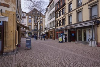 Old town with cobblestones, half-timbered houses, retail shops and restaurants in Colmar,