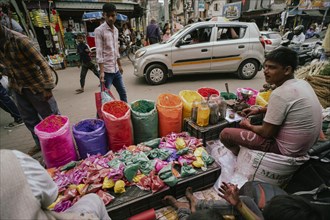 Vendor sells Holi celebration items in a street market, ahead of Holi festival on March 23, 2024 in