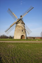 Windmill Auf der Hoechte under a cloudless blue sky is part of the Westphalian Mill Road in Hille,