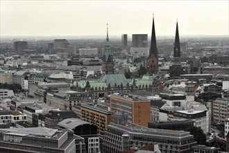 Wide view over a city with church towers and roofs under a cloudy sky, Hamburg, Hanseatic City of