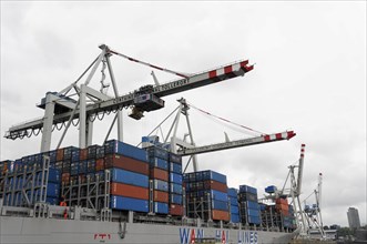 View of a container terminal with cranes and a loaded container ship, Hamburg, Hanseatic City of