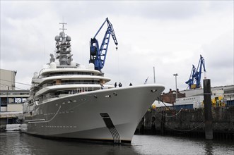 A large white luxury yacht moored in the harbour on a cloudy day, Hamburg, Hanseatic City of
