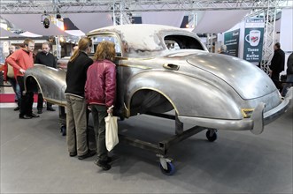 RETRO CLASSICS 2010, Stuttgart Messe, People look at the unfinished restoration of the bodywork of
