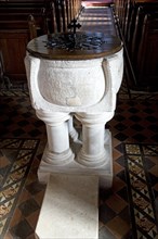 Carved limestone stonework baptismal font, All Saints church, Sudbourne, Suffolk, England, United