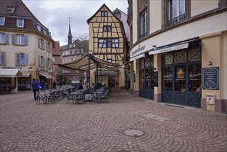 Old town with cobblestones, half-timbered houses, retail shops and restaurants in Colmar,