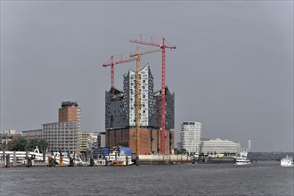 The Elbe Philharmonic Hall concert hall in Hamburg with surrounding construction site cranes and