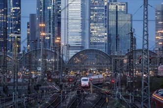 An ICE train leaves Frankfurt Central Station, the Frankfurt skyline with skyscrapers in the