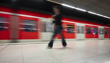 Underground arriving S-Bahn, train, class 420 in traffic red, platform, stop, station city centre,