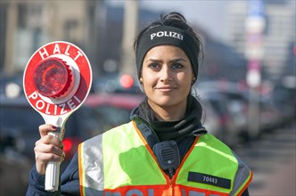 Policewoman of the Berlin police with police trowel during a traffic control, 20/03/2015