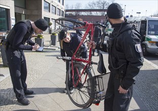Berlin police officers check the chassis number of a bicycle during a traffic stop, 20/03/2015