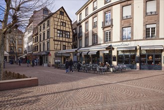 Outdoor area of a catering establishment on Place de la Cathedrale in the old town of Colmar,