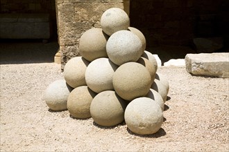 Stone sling shot balls, Archaeological museum, Rhodes, Greece, Europe