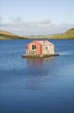Fisherman's shed on small island, Olna Firth, Voe, Shetland Islands, Scotland, United Kingdom,