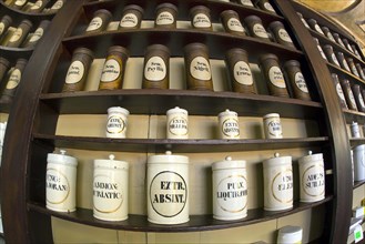 Containers with ingredients for medicines stand on a shelf in the historic Berg-Apotheke pharmacy