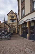 Old town with cobblestones, half-timbered houses and restaurants in Colmar, Haut-Rhin, Grand Est,