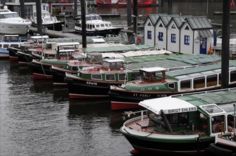 Row of launches and small boats moored at a dock in the harbour, Hamburg, Hanseatic City of
