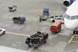 Luggage being loaded onto an aeroplane on an airport tarmac, Hamburg, Hanseatic City of Hamburg,